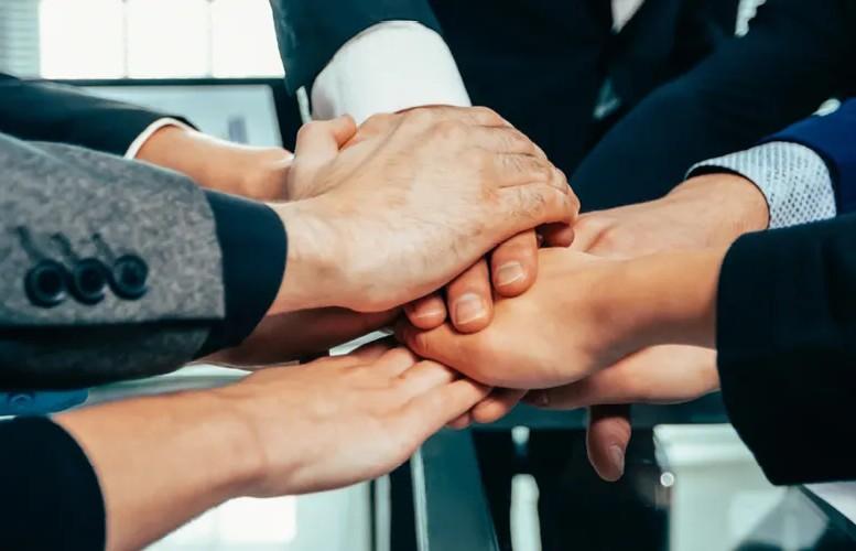team joining hands